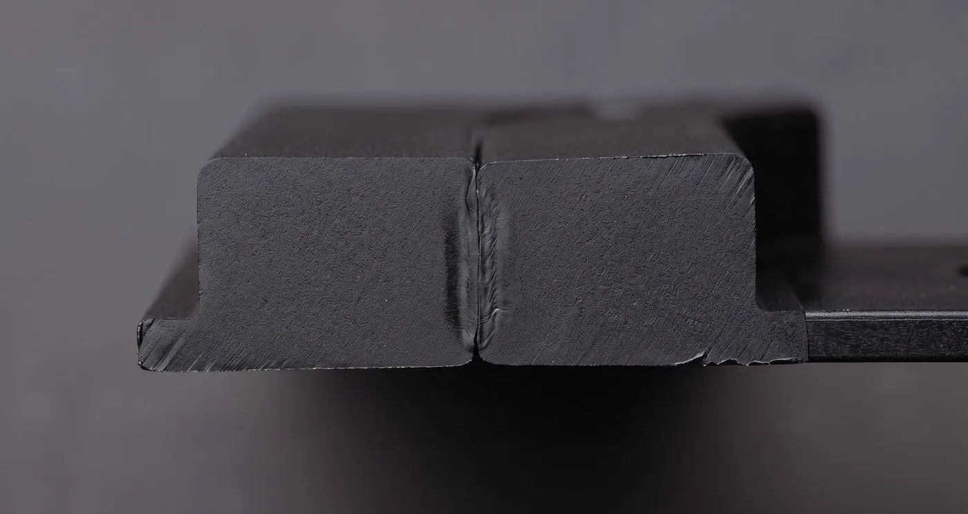 Cross-section macro of two welded thermoplastic parts showing the fused joint line