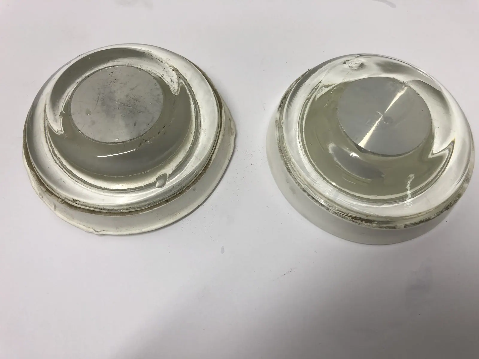 Two sizes of airfield light lens as received, deposit on the centre optic
