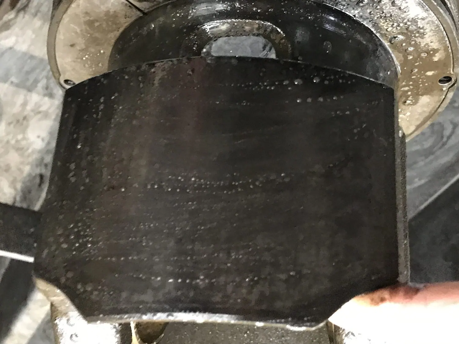Large-bore diesel piston skirt and crown covered in baked carbon