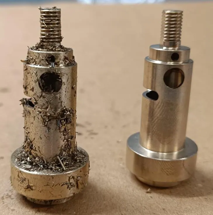Lock stem pair — chips held on the thread and boss, and clean after the cycle.