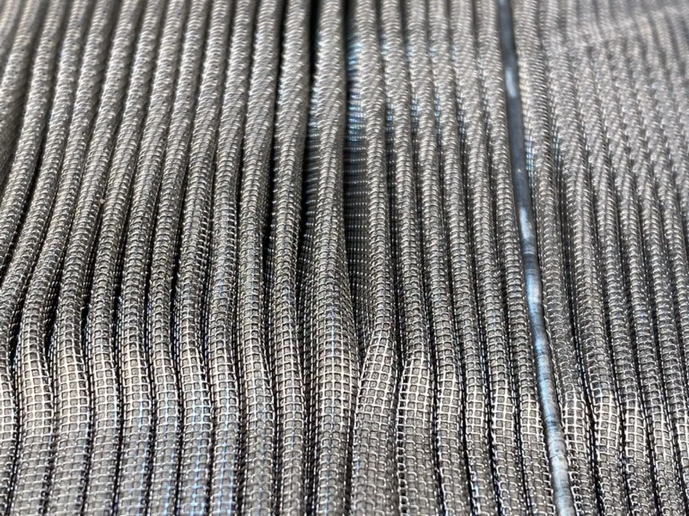 Macro of the cleaned wire cloth, individual warp and weft wires visible