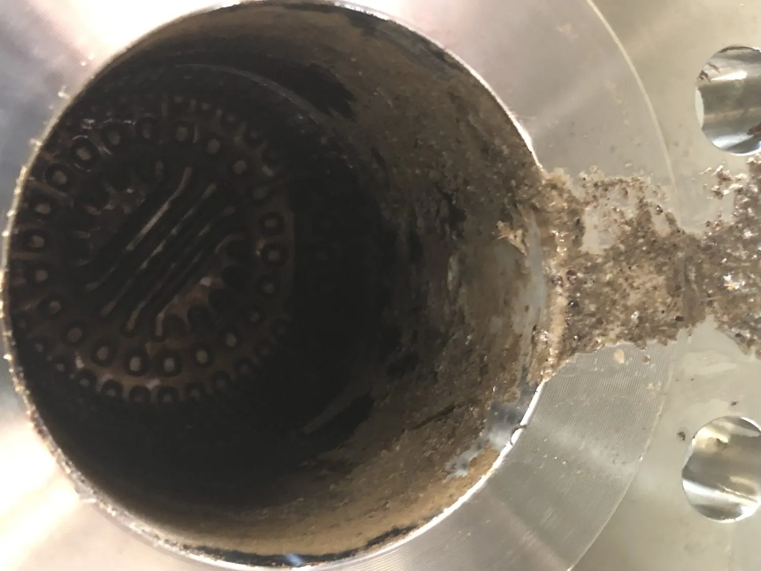 Heat exchanger tube ends bridged with scale and oil sludge