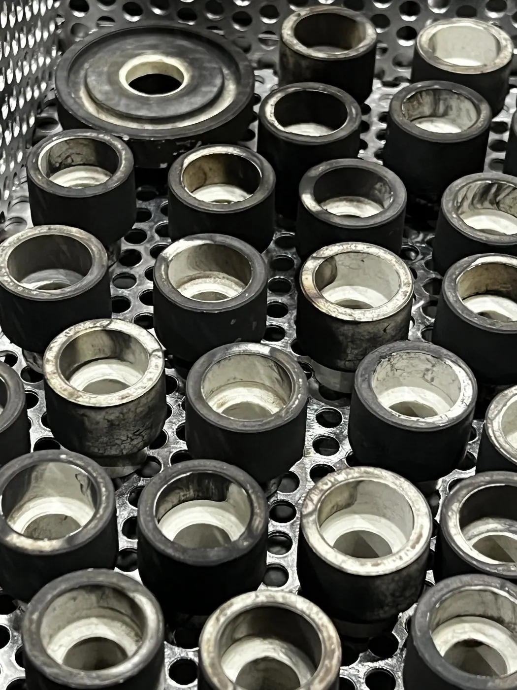 Carbon-fouled components before ultrasonic cleaning