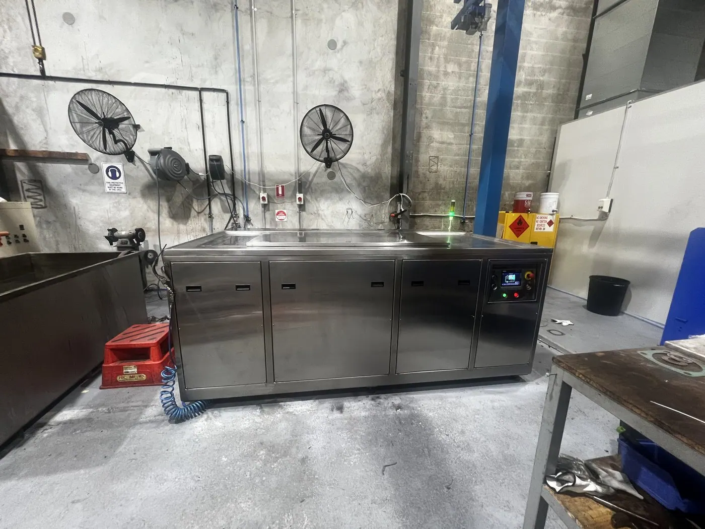 Misonics EVS 800 ultrasonic tank in service on a workshop floor beside a parts bench