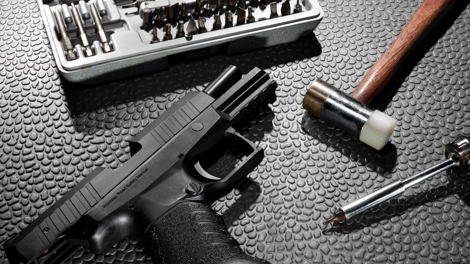 Armourer's bench with service pistol and maintenance tools