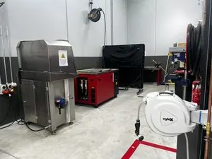 Misonics MSX 240 industrial ultrasonic cleaner — In the wash bay at a truck service centre, beside the spray parts washer