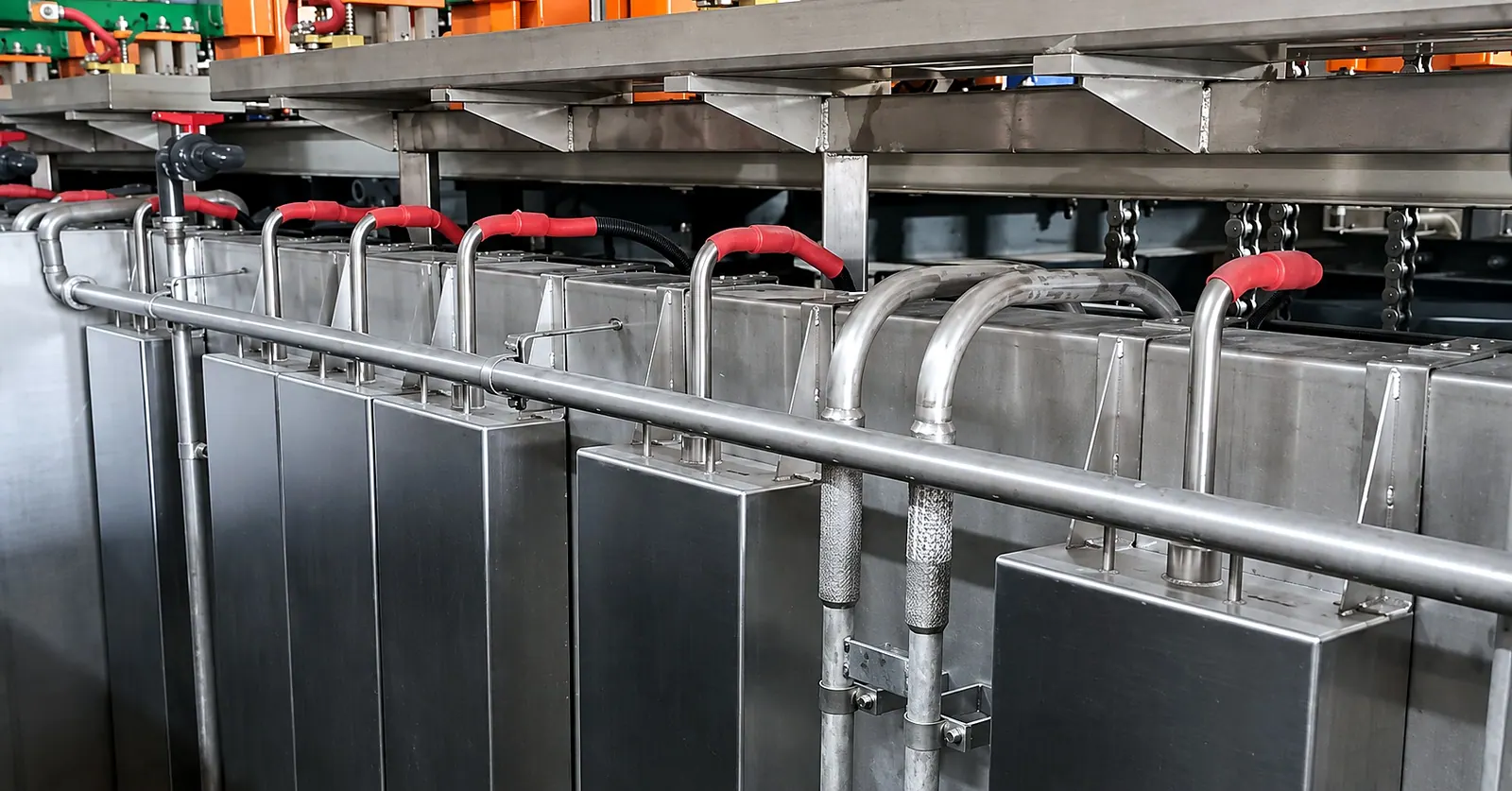 Immersible transducer boxes hung between the existing pipework and valves on a plating line