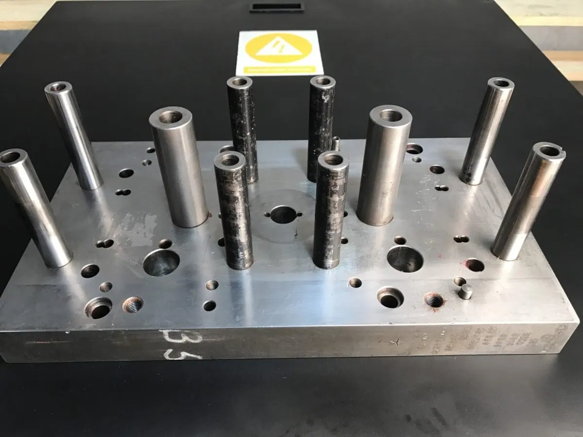 Ejector pins in a die plate — before and after ultrasonic cleaning — after the cycle