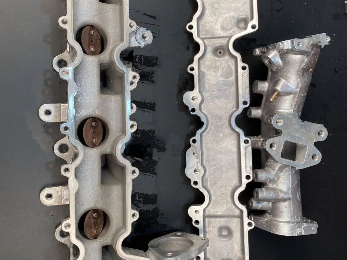 A pair of manifolds, as received — before and after ultrasonic cleaning — after the cycle