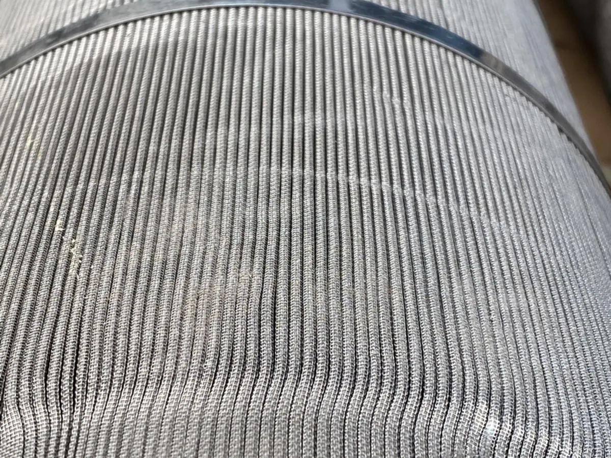 The same element after cleaning, every pleat open and the wire weave visible