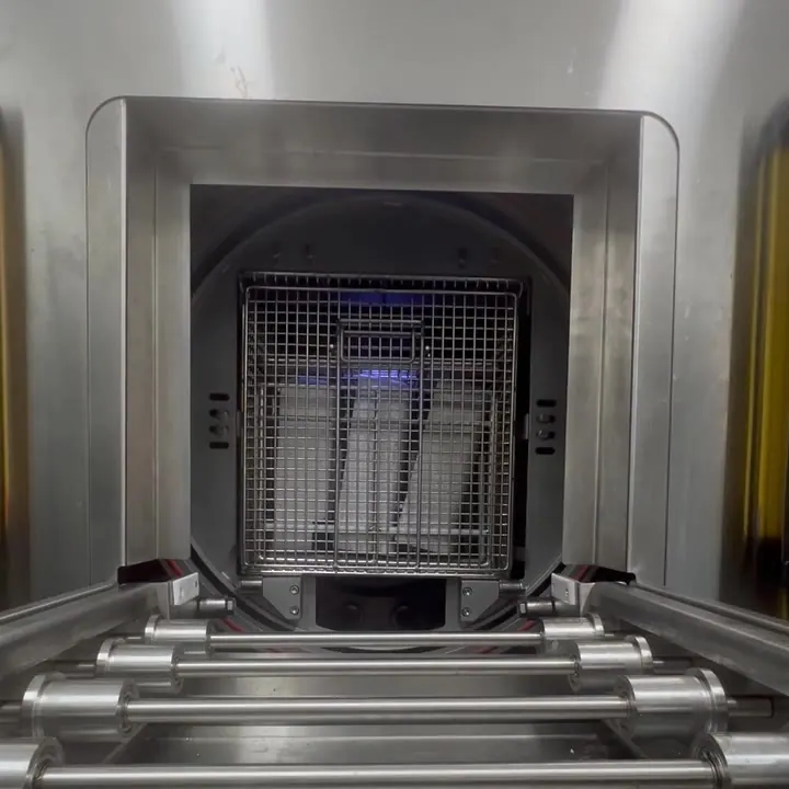 Clip: the door opens and the basket rolls out onto the conveyor